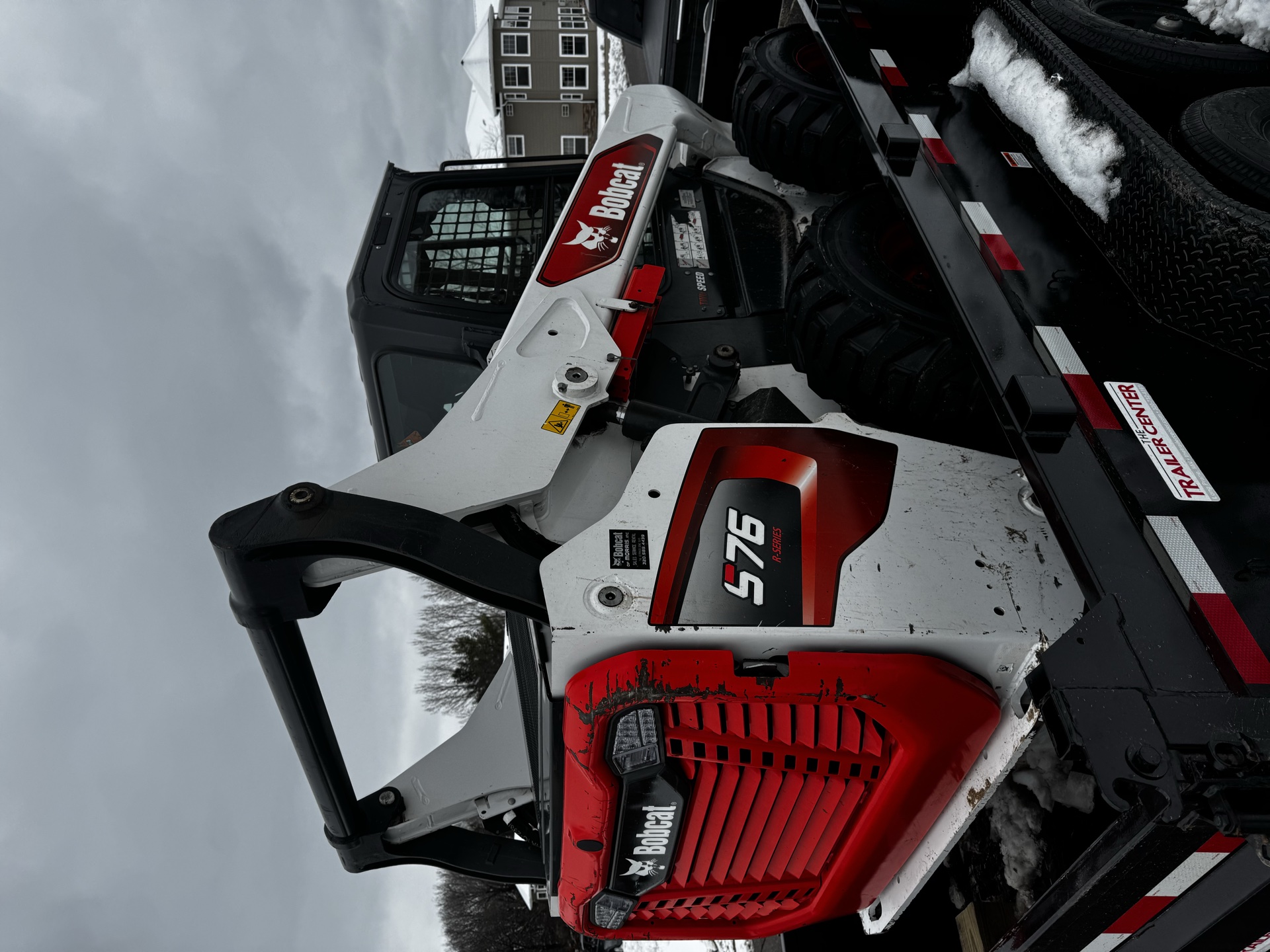 Skid loader on trailer