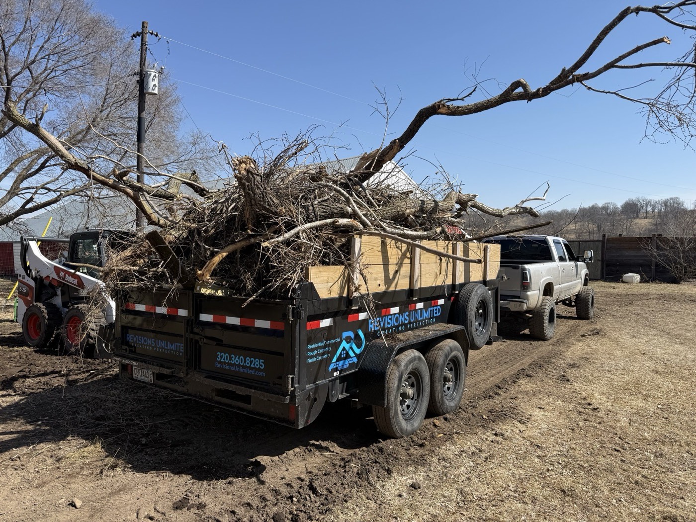 Dump trailer loaded with brush and trees — land clearing job in Minnetonka MN