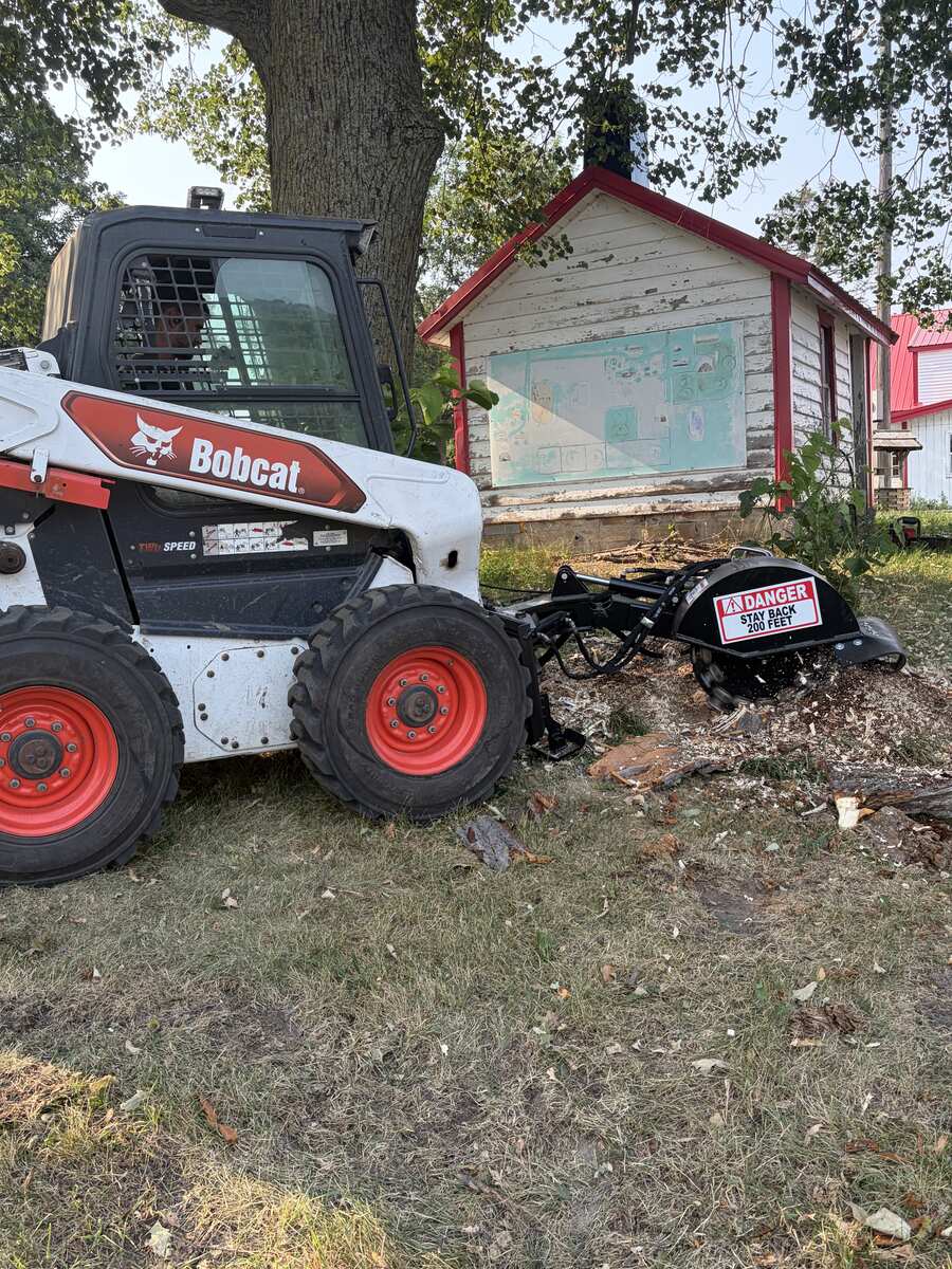 Our Bobcat with dedicated stump grinder attachment on site in Central MN